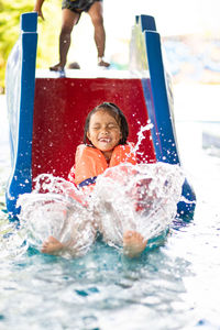 Portrait of happy girl in swimming pool