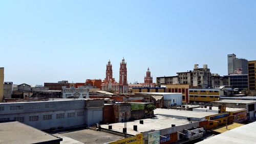 View of cityscape against clear sky