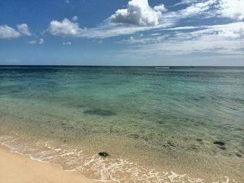 Scenic view of sea against cloudy sky