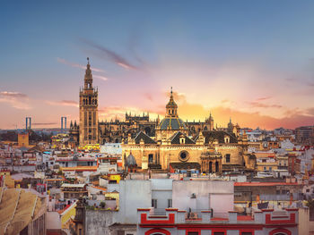 View of buildings in city at sunset