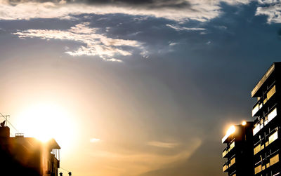 Low angle view of building against sky at sunset