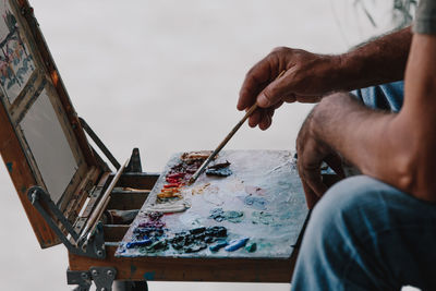 Midsection of man working on table