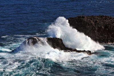 Waves breaking against sea