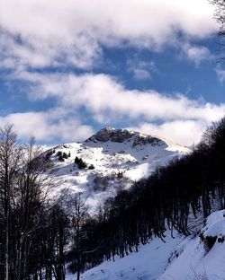 Scenic view of snow covered mountains against sky