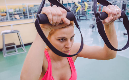 Woman exercising with resistance band at gym