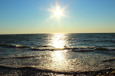 Scenic view of sea against clear sky during sunset