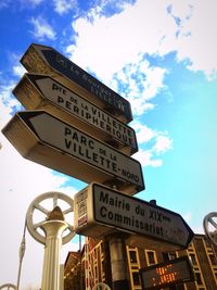 Low angle view of information sign against blue sky