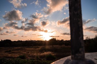 Scenic view of silhouette field against sky during sunset