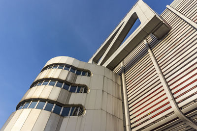 Low angle view of international congress center against clear blue sky