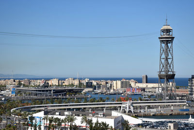 Tower amidst buildings in city against clear sky