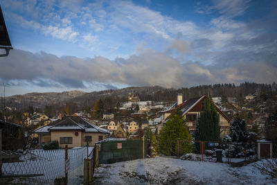 Buildings in town against sky