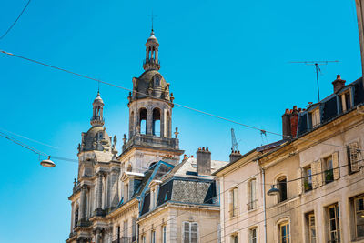 Low angle view of buildings against blue sky