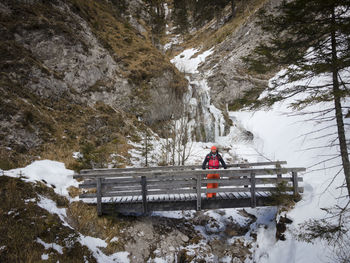 Rear view of man on snowcapped mountain