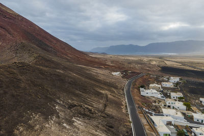 High angle view of road amidst mountains against sky