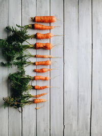 High angle view of carrots arranged on wooden table