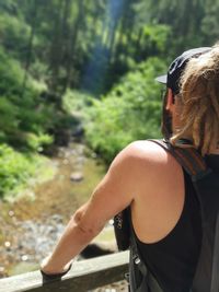 Rear view of hiker standing in forest