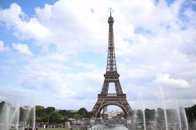 Low angle view of tower against cloudy sky