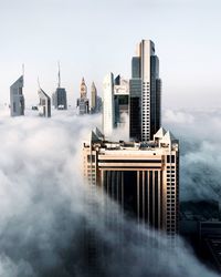 Modern buildings in city against sky