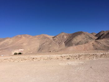 Scenic view of mountains against blue sky