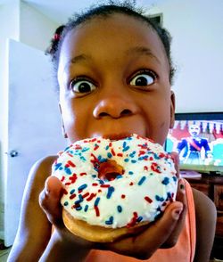 Portrait of cute girl eating food at home