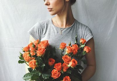 Midsection of woman holding bouquet