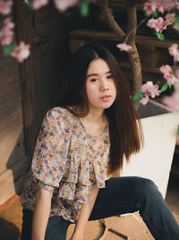Portrait of young woman sitting outdoors