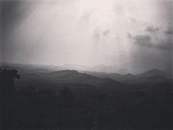 Scenic view of mountains against cloudy sky