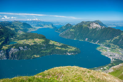 Aerial view of lake and mountains against blue sky