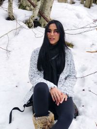 Portrait of woman in snow on field