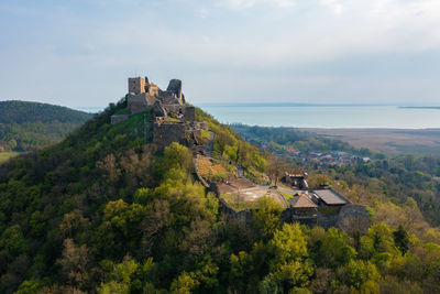 Aerial view about castle of szigliget with lake balaton at the background. spring landscape.