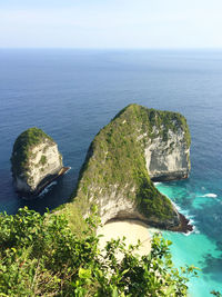 High angle view of rock formation in sea against sky