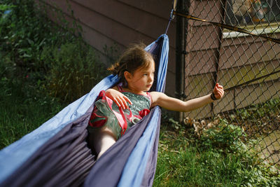 Full length of woman in front of fence