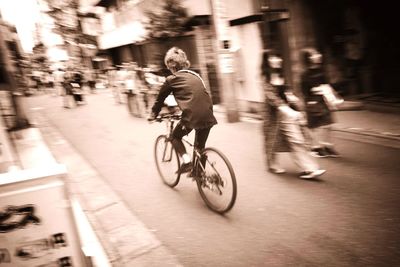 Man riding bicycle on road