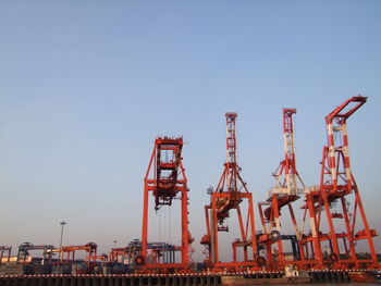 Cranes against clear sky