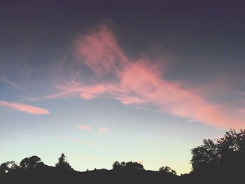 Low angle view of silhouette trees against sky at sunset