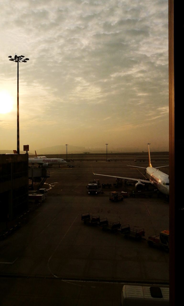 AIRPLANE ON RUNWAY AGAINST SKY