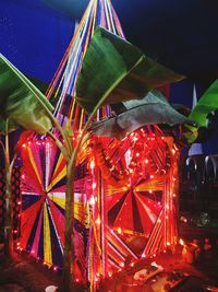 Close-up of illuminated ferris wheel at night