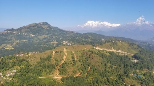 High angle view of field and mountains against sky