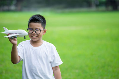 Portrait of boy wearing mask on field