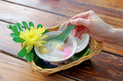 Cropped hand of woman holding potted plant