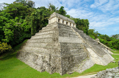 Exterior of temple of inscriptions against trees