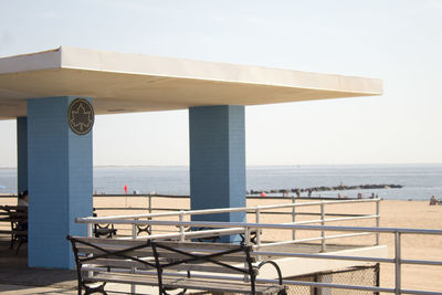 Lifeguard hut on beach against clear sky