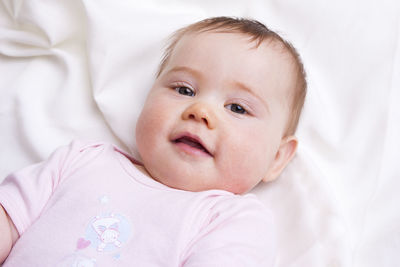 Close-up of cute baby boy sleeping on bed