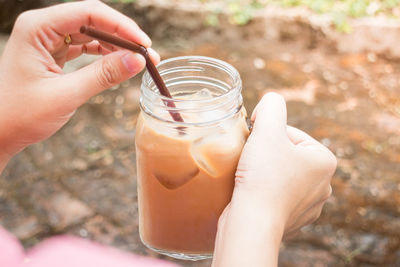 Close-up of hands holding drink