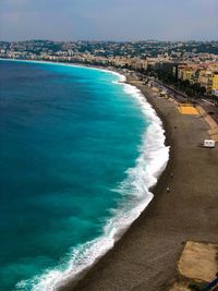 Scenic view of sea and city against sky