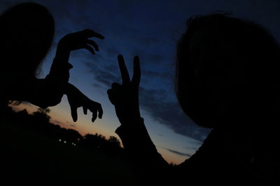 Silhouette people against sky during sunset