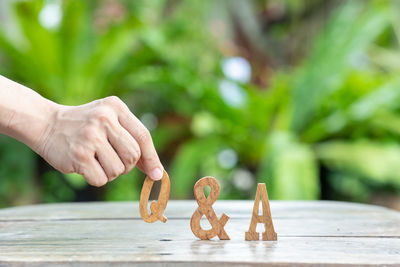 Close-up of person holding hands on table