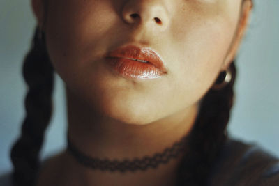 Cropped image of young woman wearing choker