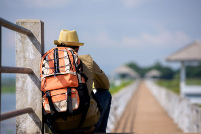 Rear view of man wearing hat against sky