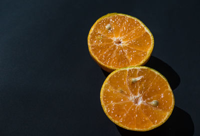 Close-up of orange slices against black background